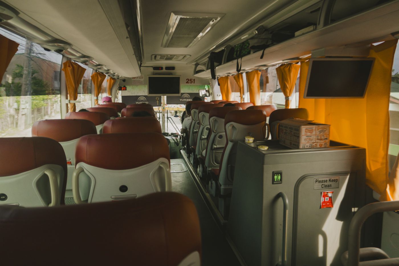 Premium motorcoach interior with leather reclining seats and overhead storage